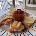food on a plate with a gate and dock in the background.